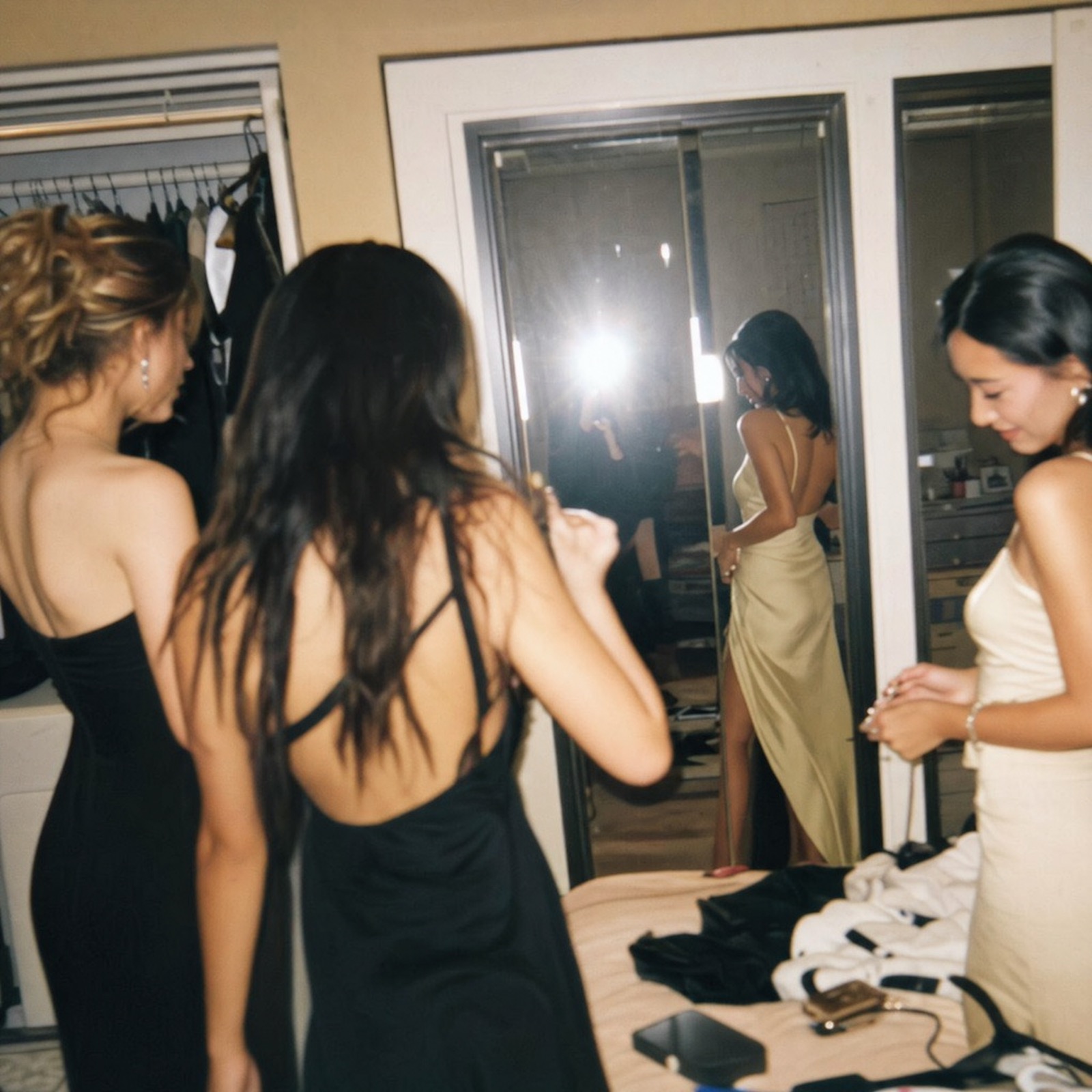 Friends getting ready together in gowns before a night out
